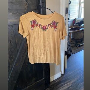 This is a mustard yellow color T-shirt, Size Small
